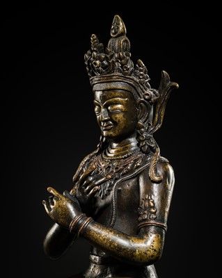 Lot 301 - A SILVER AND COPPER INLAID BRONZE FIGURE OF VAJRADHARA, TIBET, 14TH-15TH CENTURY