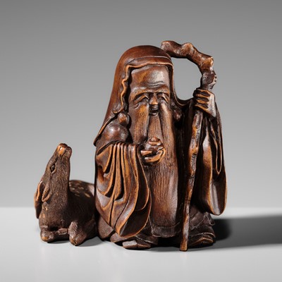 Lot 471 - MASANAO: A CHARMING WOOD OKIMONO NETSUKE OF JUROJIN WITH A DEER