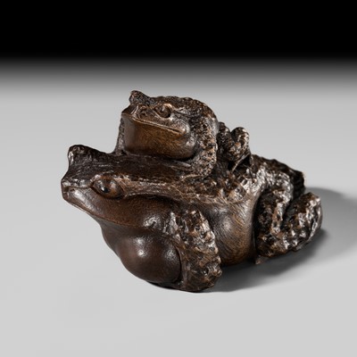 HARUMITSU: A FINE YAMADA SCHOOL CAMPHOR WOOD OKIMONO OF TWO TOADS