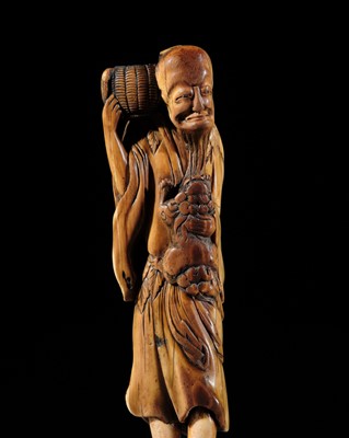 A VERY LARGE IVORY NETSUKE OF A SENNIN WITH SHISHI
