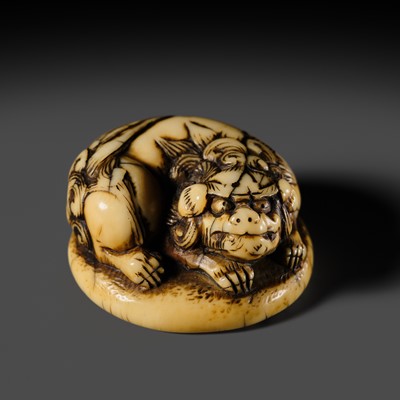Lot 103 - OKAKOTO: A FINE IVORY NETSUKE OF A SHISHI ON A BASE