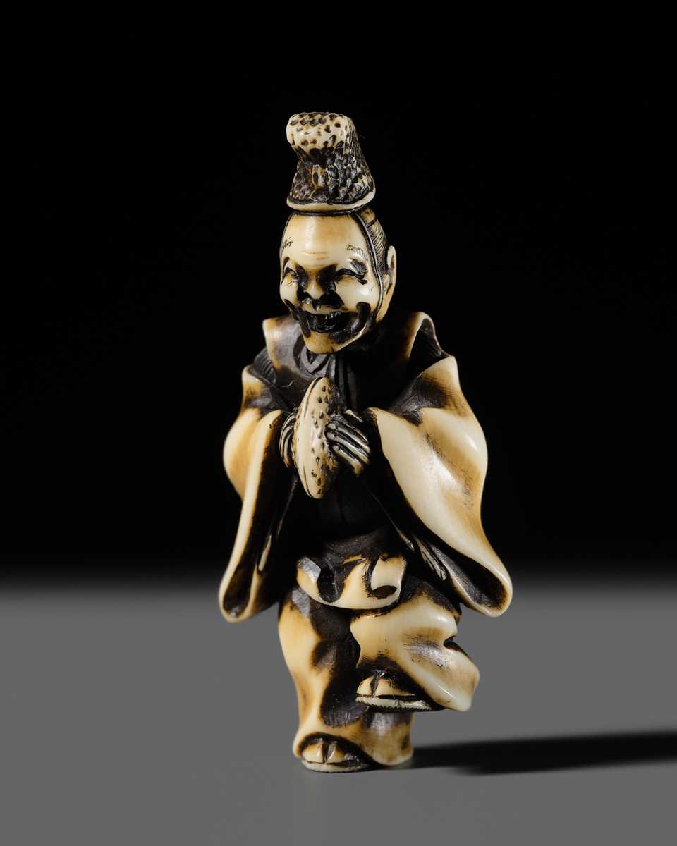 Lot 133 - HIDEMASA: A FINE IVORY NETSUKE OF A COURTIER