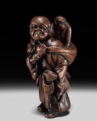 Lot 178 - HASEGAWA IKKO: A WOOD NETSUKE OF A SARUMAWASHI (MONKEY TRAINER)