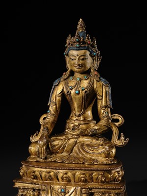 Lot 14 - A GILT COPPER ALLOY FIGURE OF BUDDHA AKSHOBHYA, PROBABLY JONANG LINEAGE, TIBET, 14TH-15TH CENTURY