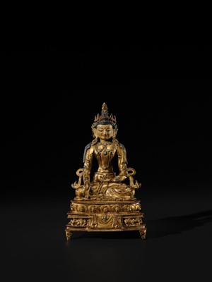 Lot 14 - A GILT COPPER ALLOY FIGURE OF BUDDHA AKSHOBHYA, PROBABLY JONANG LINEAGE, TIBET, 14TH-15TH CENTURY
