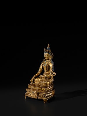 Lot 14 - A GILT COPPER ALLOY FIGURE OF BUDDHA AKSHOBHYA, PROBABLY JONANG LINEAGE, TIBET, 14TH-15TH CENTURY