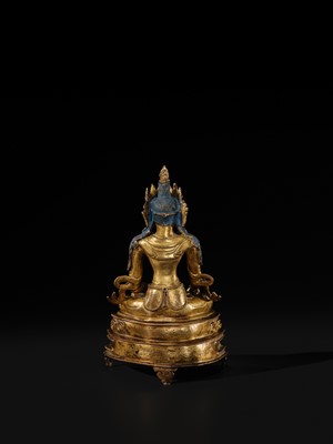 Lot 14 - A GILT COPPER ALLOY FIGURE OF BUDDHA AKSHOBHYA, PROBABLY JONANG LINEAGE, TIBET, 14TH-15TH CENTURY