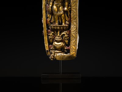 A GILT-COPPER REPOUSSÉ RELIEF DEPICTING PADMAPANI LOKESHVARA, TIBET, 14TH-15TH CENTURY