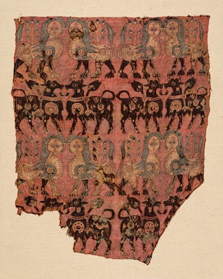 Lot 197 - AN ANCIENT AND VERY RARE SILK FRAGMENT WITH CONFRONTING LIONS AND BULLS, SOGDIANA, CIRCA 650 AD