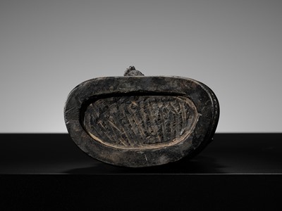 Lot 20 - A FINELY CARVED BLACK STONE FIGURE OF JAMBHALA, TIBET, 15TH-17TH CENTURY