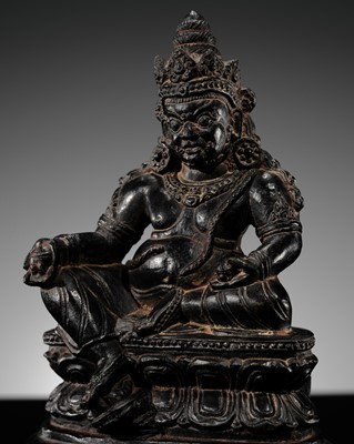 Lot 20 - A FINELY CARVED BLACK STONE FIGURE OF JAMBHALA, TIBET, 15TH-17TH CENTURY