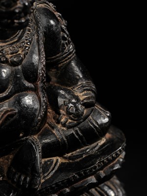Lot 20 - A FINELY CARVED BLACK STONE FIGURE OF JAMBHALA, TIBET, 15TH-17TH CENTURY
