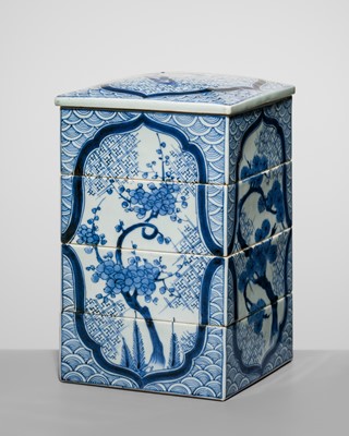 Lot 219 - A FOUR-TIERED ARITA BLUE AND WHITE PORCELAIN JUBAKO (STACKING BOX AND COVER)
