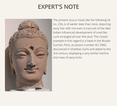 Lot 235 - A MAGNIFICENTLY MODELED OVER-LIFESIZE STUCCO HEAD OF BUDDHA, ANCIENT REGION OF GANDHARA, 3RD TO 4TH CENTURY