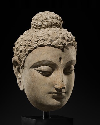 Lot 236 - A LARGE AND IMPORTANT STUCCO HEAD OF BUDDHA, ANCIENT REGION OF GANDHARA, 3RD TO 4TH CENTURY