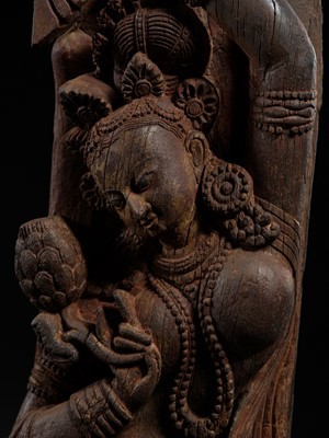 Lot 299 - A CARVED WOOD TEMPLE STRUT DEPICTING A SHALABHANJIKA, NEPAL, MALLA PERIOD, CIRCA 13TH-15TH CENTURY