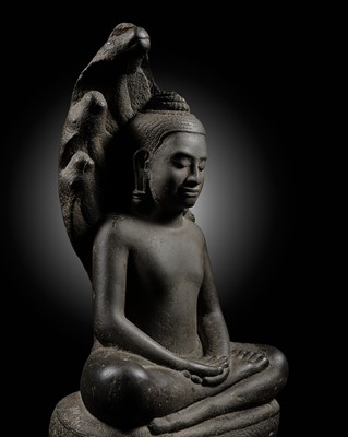 Lot 253 - A KHMER SANDSTONE FIGURE OF BUDDHA MUCHALINDA, ANGKOR PERIOD, BAYON STYLE, LATE 12TH-EARLY 13TH CENTURY