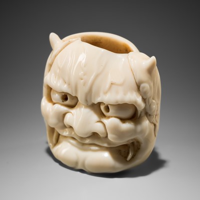 SEISAI: A HUMOROUS IVORY ‘DOUBLE MASK’ NETSUKE OF AN ONI AND USOFUKI