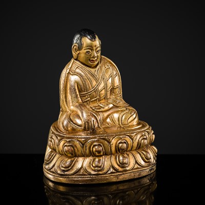Lot 36 - A MINIATURE GILT-BRONZE FIGURE OF A LAMA, TIBET, 15TH-16TH CENTURY