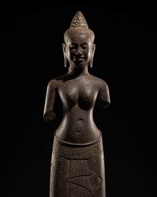 Lot 411 - A SANDSTONE FIGURE OF A FEMALE DEITY, ANGKOR PERIOD, BAYON STYLE, LATE 12TH-EARLY 13TH CENTURY