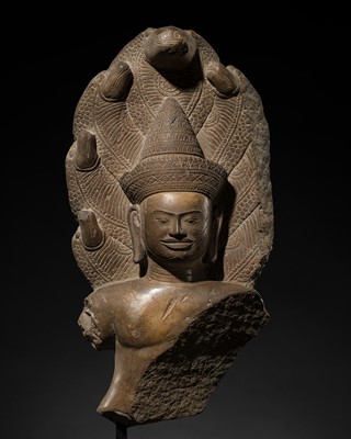 Lot 266 - A POLISHED SANDSTONE BUST OF BUDDHA MUCHALINDA, ANGKOR WAT STYLE, FIRST HALF OF THE 12TH CENTURY