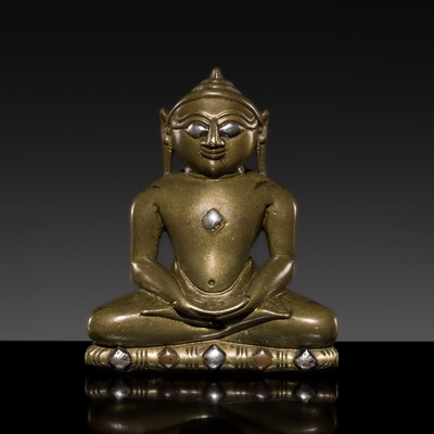 Lot 620 - A SMALL JAIN SILVER- AND COPPER-INLAID BRASS FIGURE OF A TIRTHANKARA, WESTERN INDIA, 16TH-17TH CENTURY OR EARLIER