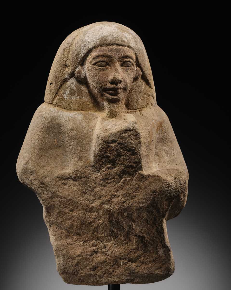 Lot 12 - A RARE EGYPTIAN SANDSTONE FRAGMENT OF A STELOPHOROUS STATUE DEPICTING AN IRY-PAT, NEW KINGDOM, 19TH DYNASTY