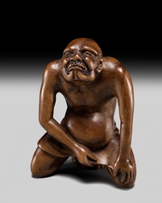 Lot 242 - AN EARLY AND AMUSING EDO SCHOOL WOOD NETSUKE OF A MAN LIFTING HIS LOINCLOTH
