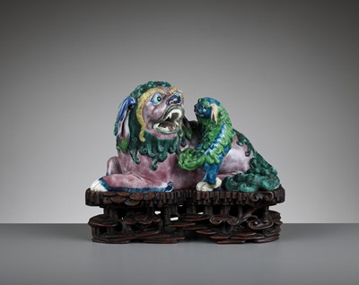 Lot 286 - A BISCUIT PORCELAIN MODEL OF A BUDDHIST LION AND CUB, QING DYNASTY