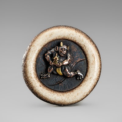 Lot 540 - AN AMUSING ANTLER SHIBUICHI KAGAMIBUTA NETSUKE DEPICTING AN ONI