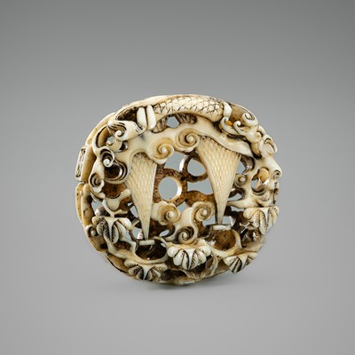 HO: A WALRUS TUSK RYUSA MANJU NETSUKE DEPICTING FISHER NETS AMONG TURBULENT WAVES