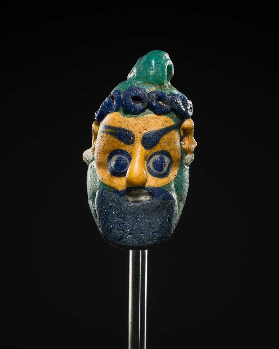 Lot 60 - A CARTHAGINIAN GLASS HEAD PENDANT, CIRCA 5TH-4TH CENTURY BC