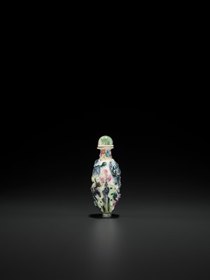 Lot 398 - A MOLDED AND ENAMELED PORCELAIN ‘MYTHICAL BEASTS’ SNUFF BOTTLE, QING DYNASTY