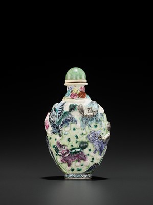 Lot 398 - A MOLDED AND ENAMELED PORCELAIN ‘MYTHICAL BEASTS’ SNUFF BOTTLE, QING DYNASTY