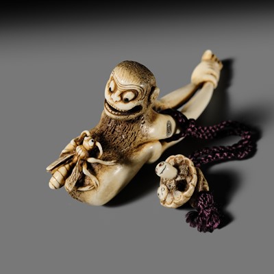 Lot 375 - GENSAI: AN AMUSING CONTEMPORARY ANTLER NETSUKE OF A MONKEY AND BEE, WITH EN SUITE OJIME