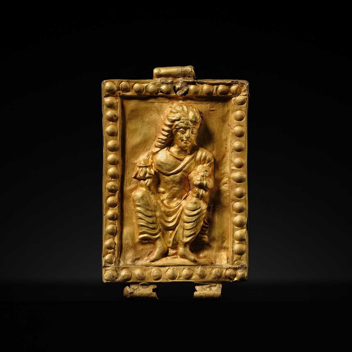 A GOLD REPOUSSÉ PENDANT OF PADMAPANI, ANCIENT REGION OF GANDHARA