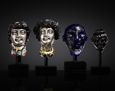 Lot 321 - A GROUP OF FOUR ANCIENT GLASS AND SILVER HEADS