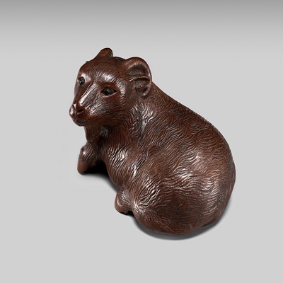 Lot 370 - MASANAO SHINZAN: A FINE WOOD NETSUKE OF A RECUMBENT GOAT