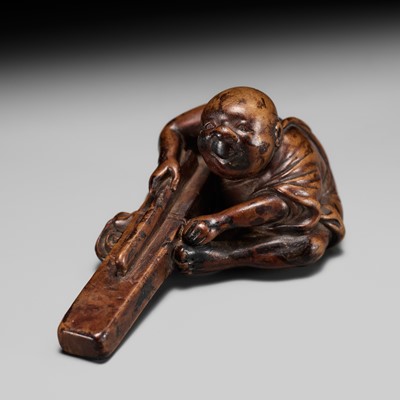 Lot 240 - AN UNUSUAL EDO SCHOOL WOOD NETSUKE OF A CARPENTER