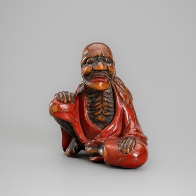 A LACQUERED WOOD NETSUKE OF SENNIN