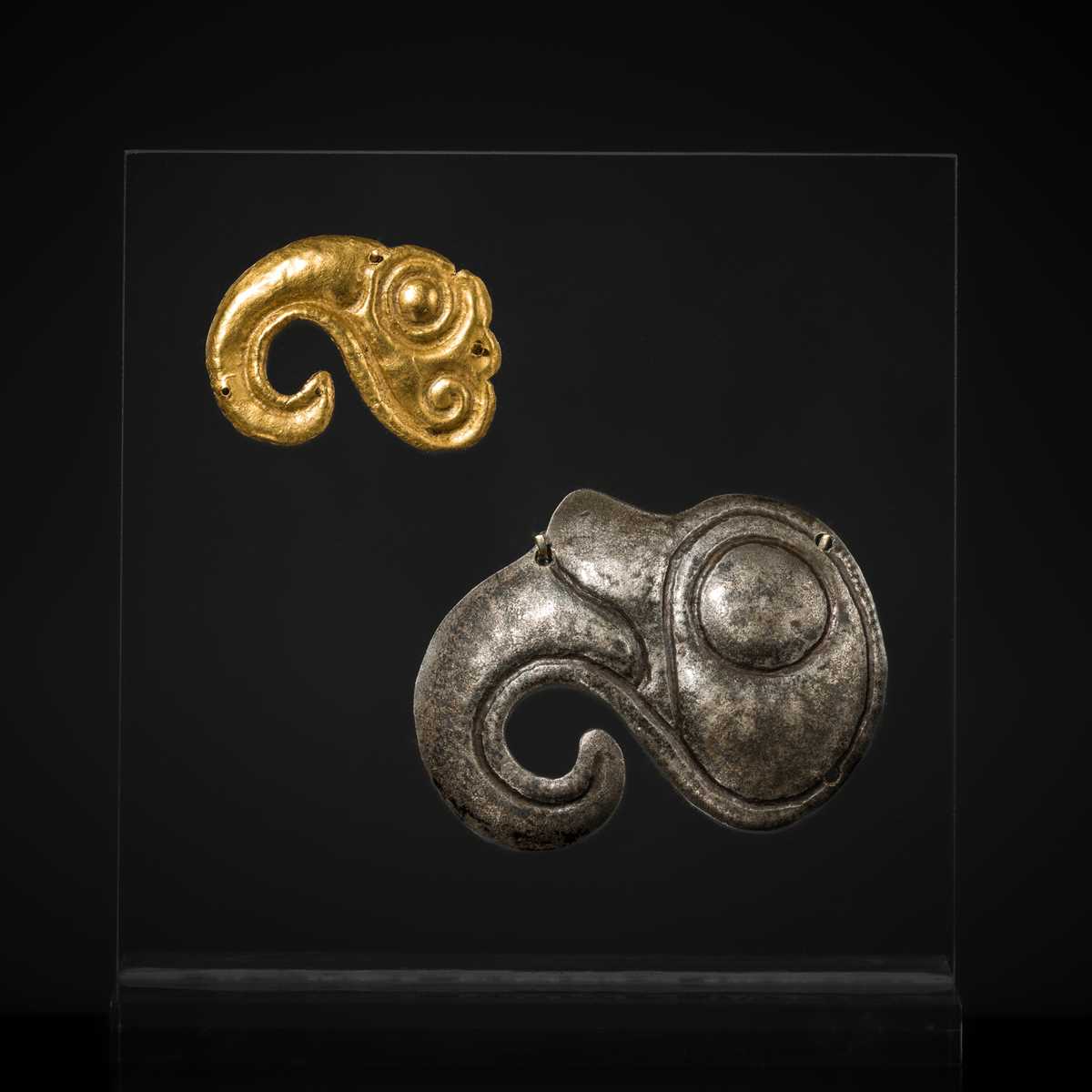Lot 89 - TWO BIRD HEAD APPLIQUÉS, ONE GOLD AND ONE SILVER, SCYTHIAN, 4TH CENTURY BC