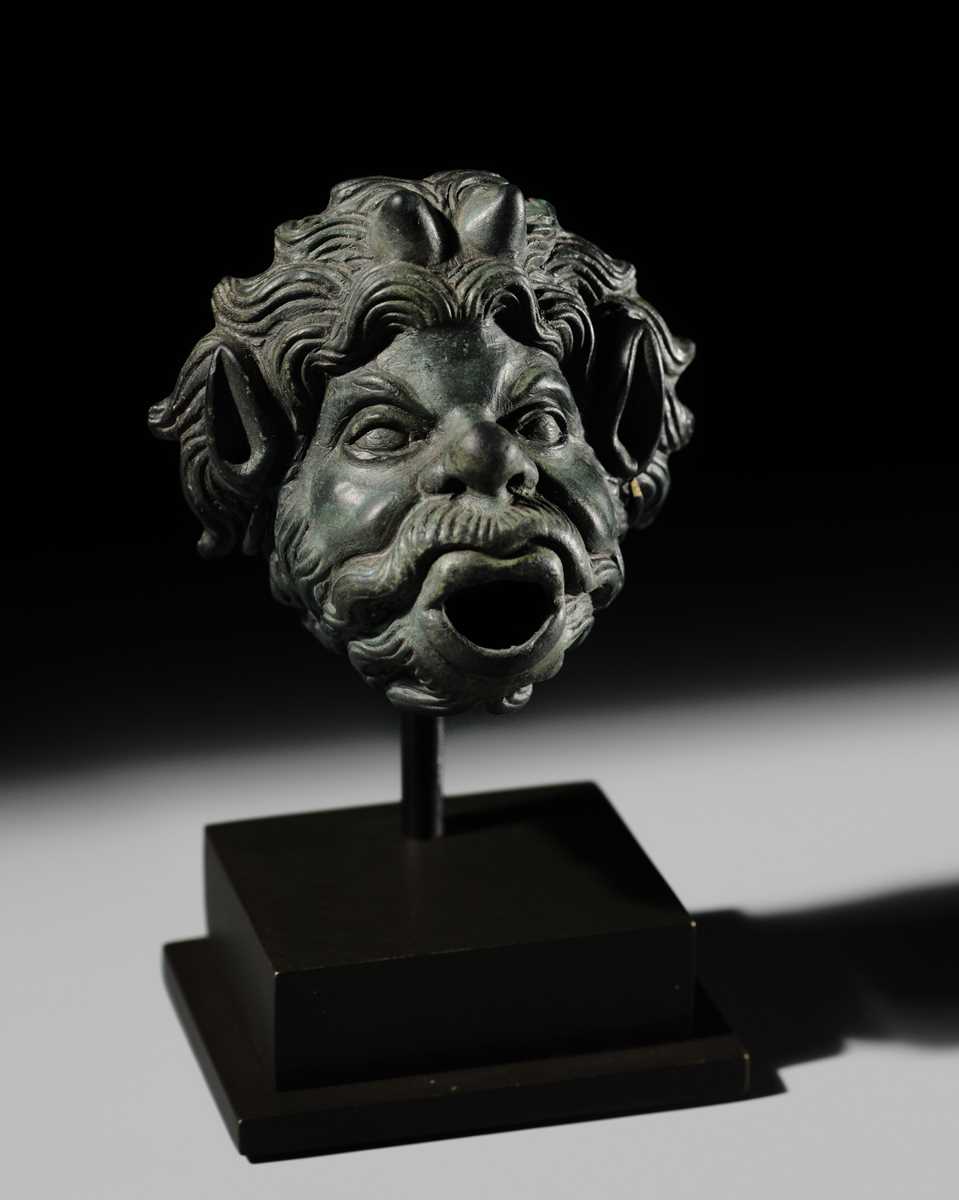 Lot 77 - A ROMAN BRONZE WATER SPOUT DEPICTING PAN, PROBABLY FROM A NYMPHAEUM, CIRCA 1ST–2ND CENTURY