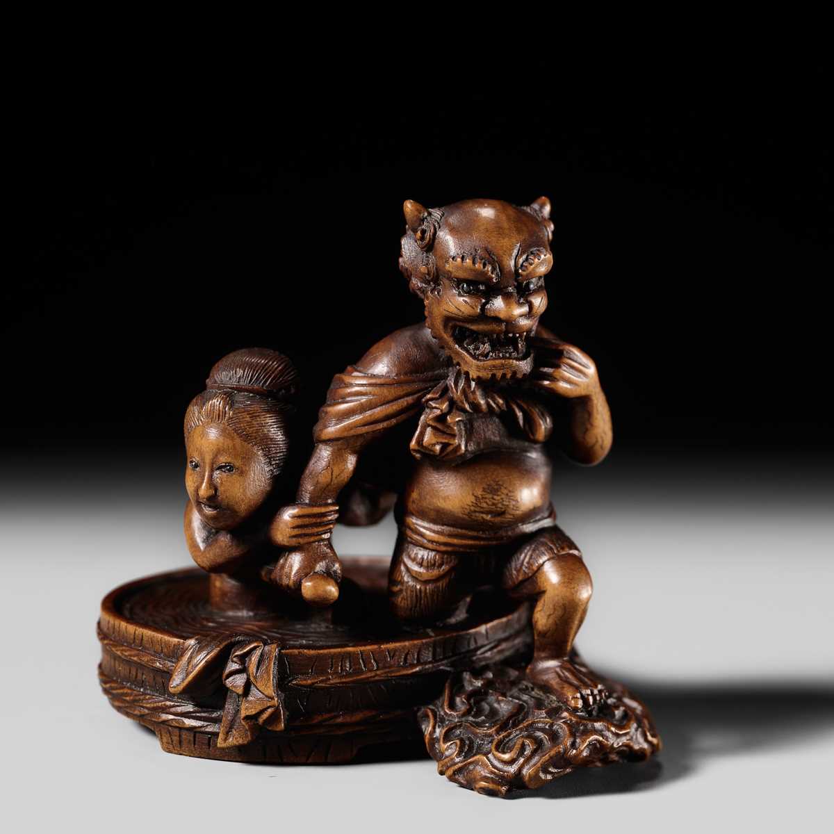 Lot 157 - SUKETADA: A WOOD NETSUKE OF RAIJIN BATHING