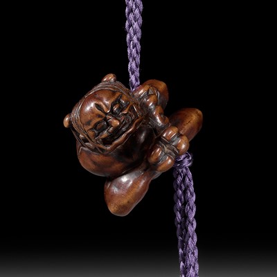 Lot 248 - A POWERFUL WOOD NETSUKE OF AN ONI