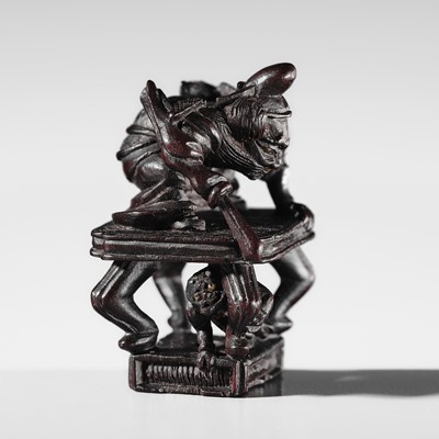 Lot 506 - EIKO: AN EXQUISITE WOOD NETSUKE OF SHOKI AND ONI