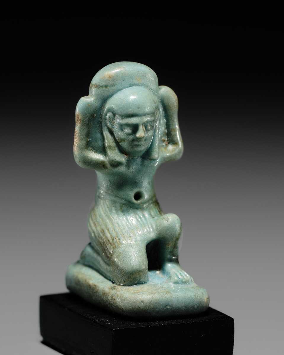 A GREEN FAIENCE AMULET OF SHU, THE GOD OF AIR AND ATMOSPHERE, LATE PERIOD, DYNASTY XXVI