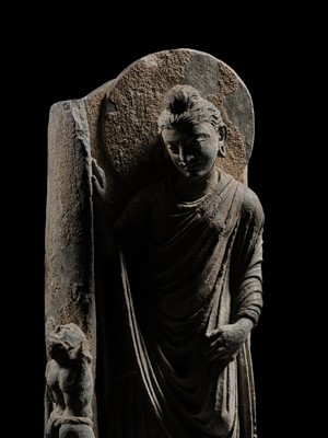 Lot 225 - A GRAY SCHIST FRIEZE OF BUDDHA DIPANKARA AND THE ASCETIC MEGHA, THE FUTURE BUDDHA SHAKYAMUNI, CIRCA 3RD CENTURY