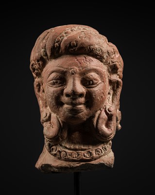 Lot 337 - A TERRACOTTA HEAD OF A FEMALE DEITY, GUPTA PERIOD, 6TH CENTURY