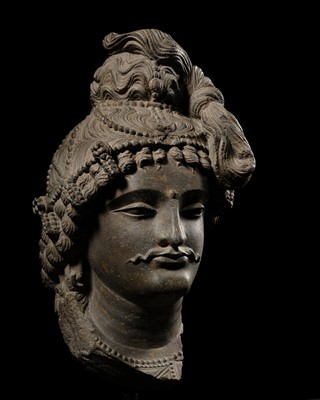Lot 234 - A MONUMENTAL GRAY SCHIST HEAD OF MAITREYA, ANCIENT REGION OF GANDHARA, 3RD-4TH CENTURY