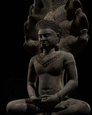 Lot 406 - A SANDSTONE FIGURE OF BUDDHA MUCHALINDA, ANGKOR WAT STYLE, 12TH-13TH CENTURY